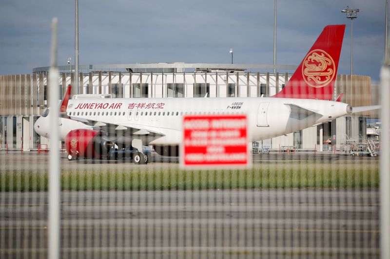 FILE PHOTO: A Juneyao Airlines Airbus A320 passenger aircraft is parked at the Airbus factory in Blagnac near Toulouse