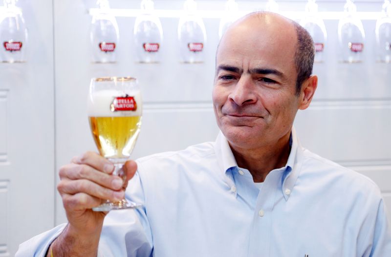 FILE PHOTO: Anheuser-Busch InBev CEO Brito poses with a Stella Artois beer after a news conference in Leuven