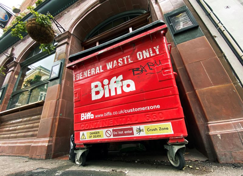 The logo of waste management company Biffa is seen on a large wheelie bin outside a pub in London