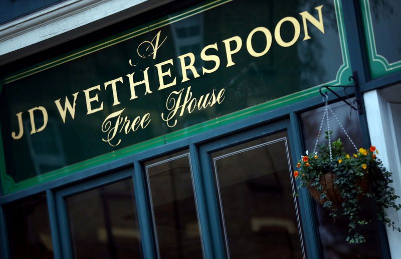 FILE PHOTO: FILE PHOTO: A Wetherspoon's logo is seen at a pub in central London