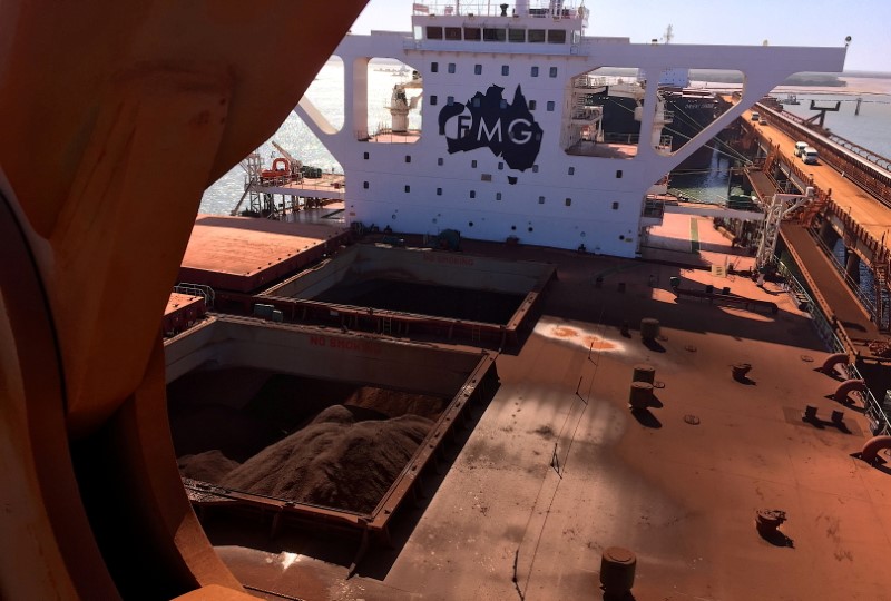 FILE PHOTO: The logo of Australia's Fortescue Metals Group can be seen on a bulk carrier as it is loaded with iron ore at the coastal town of Port Hedland in Western Australia