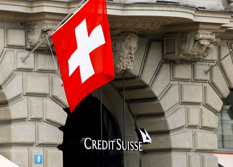 FILE PHOTO: Switzerland's national flag flies above the logo of Swiss bank Credit Suisse in Zurich