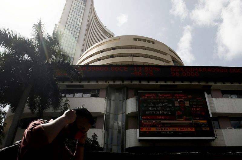 FILE PHOTO: A man walks past the Bombay Stock Exchange (BSE) building in Mumbai