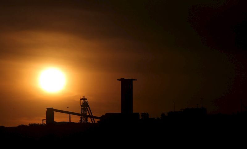 Sun sets behind a shaft outside the mining town of Carletonville