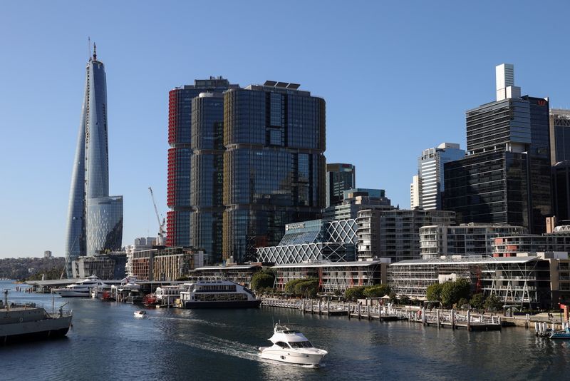 A boat navigates Darling Harbour past the Central Business District waterfront in Sydney