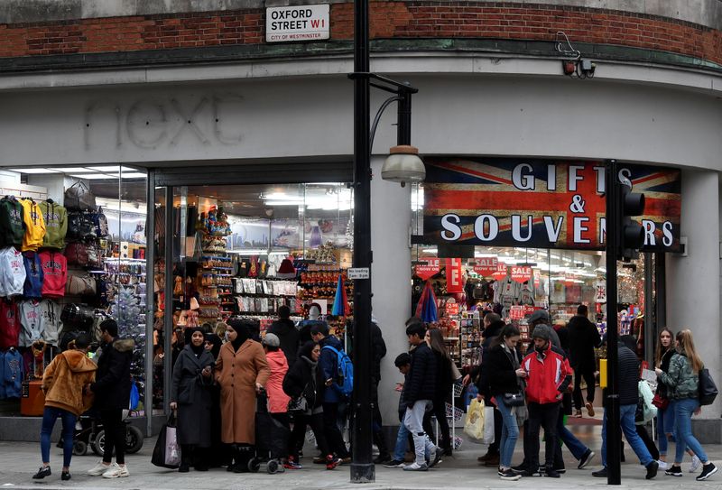 Shoppers walk past a former branch of the British clothing retailer Next, now converted into an independent gift shop on Oxford Street in London, Britain
