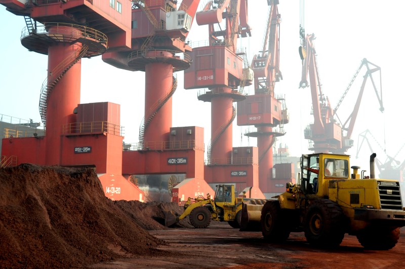 FILE PHOTO: Workers transport soil containing rare earth elements for export at a port in Lianyungang