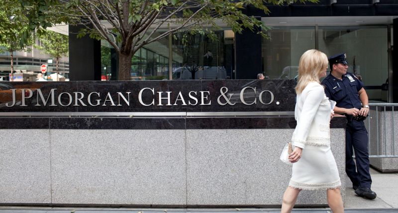 FILE PHOTO: A woman walks past JPMorgan Chase & Co's international headquarters on Park Avenue in New York