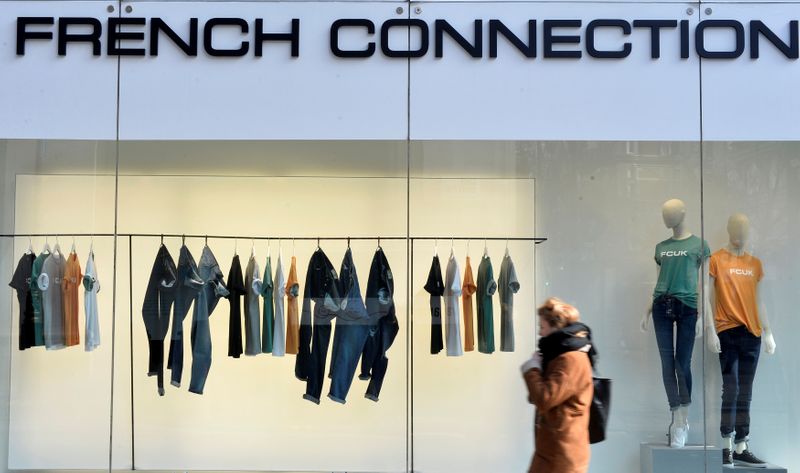 FILE PHOTO: A person walks past a French Connection store in London, Britain