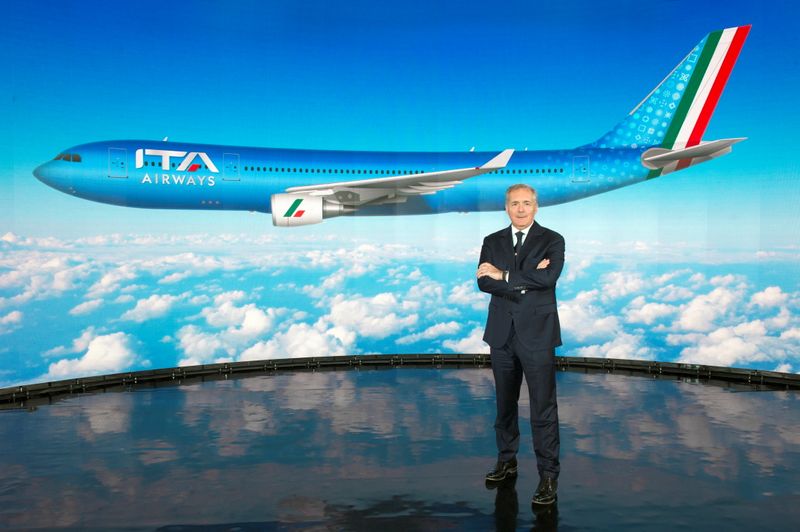 ITA Airways Chairman Alfredo Altavilla poses with the image of the new livery for the carrier's jets