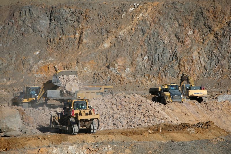 FILE PHOTO: Wheel loaders fill trucks with ore at the MP Materials rare earth mine in Mountain Pass