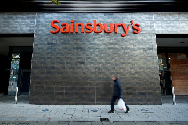 FILE PHOTO: A person walks past a Sainsbury's store in Milton Keynes