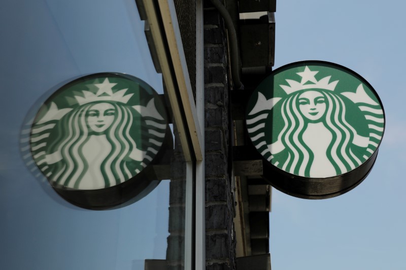 A Starbucks logo hangs outside of one of the 8,000 Starbucks-owned American stores that will close around 2 p.m. local time on Tuesday as a first step in training 175,000 employees on racial tolerance in the Brooklyn borough of New York