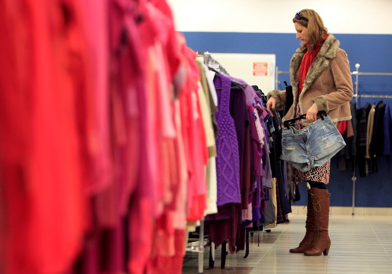 FILE PHOTO: A customer looks at clothes on display at a store of a major second hand clothes importer in Budapest, Hungary