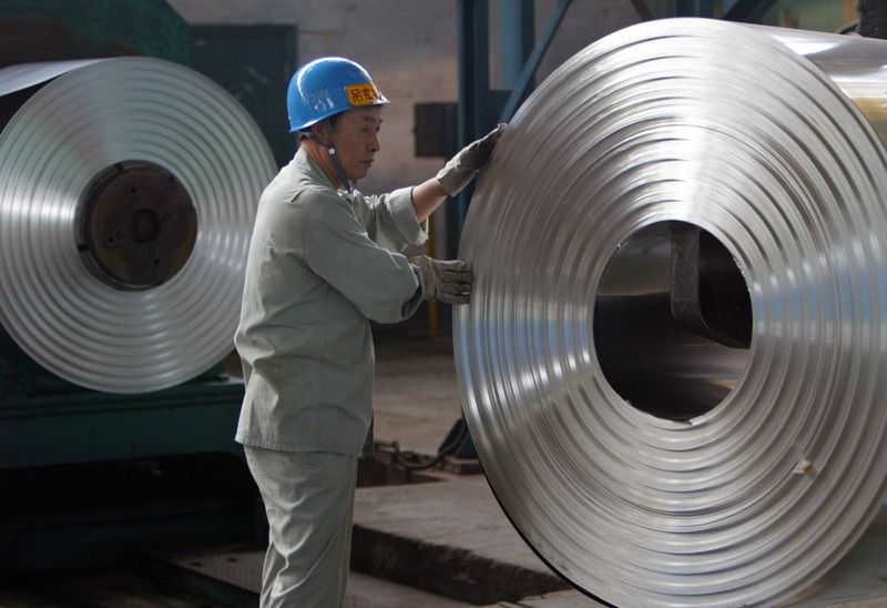 Labourer works at cold-rolling mill of Wuhan Iron & Steel Group on outskirts of Wuhan