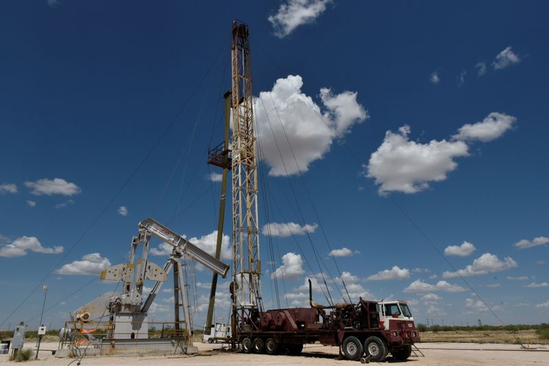 FILE PHOTO: A work over rig performs maintenance on an oil well in the Permian Basin oil production area near Wink