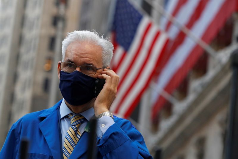 A trader speaks on a phone outside the New York Stock Exchange (NYSE) following Election Day in Manhattan, New York City