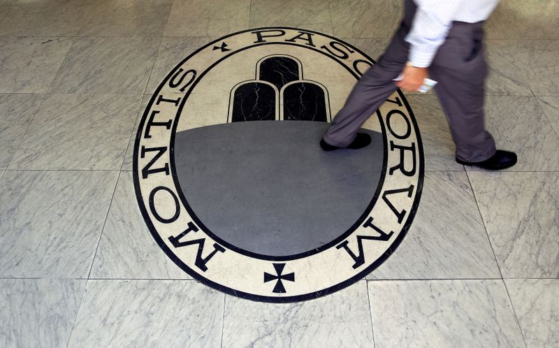 FILE PHOTO: A man walks across the logo of the Monte dei Paschi di Siena bank in Rome