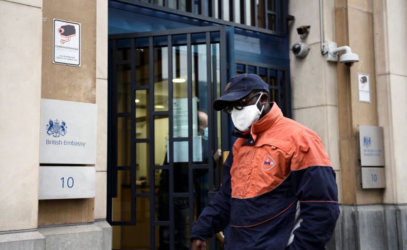 FILE PHOTO: A PostNL employee is seen at the entrance of the UK Mission to the EU