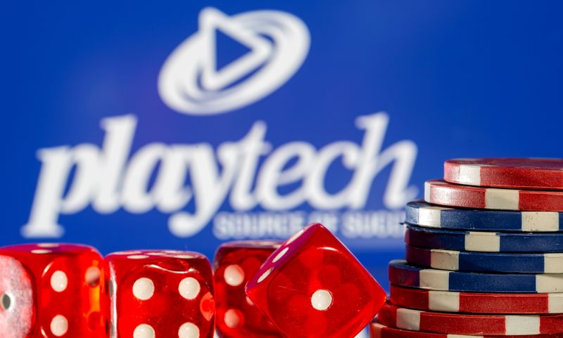 Gambling cubes and chips are seen in front of displayed Playtech logo in this illustration taken