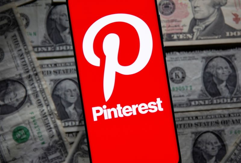 FILE PHOTO: Pinterest logo is seen on a smartphone placed over U.S. dollar banknotes in this illustration