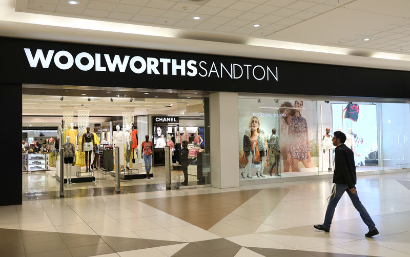 A shopper walks to a Woolworths store in Sandton