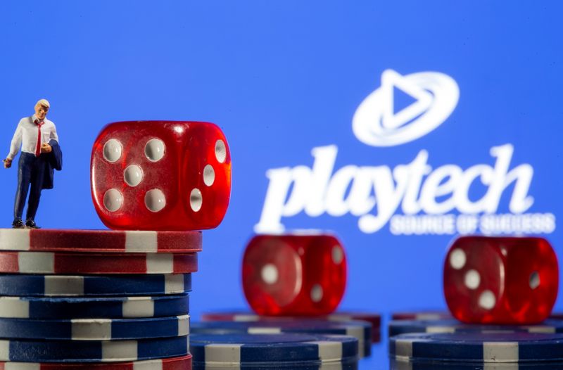 FILE PHOTO: Businessman toy figure is placed on gambling chips in front of displayed Playtech logo in this illustration taken