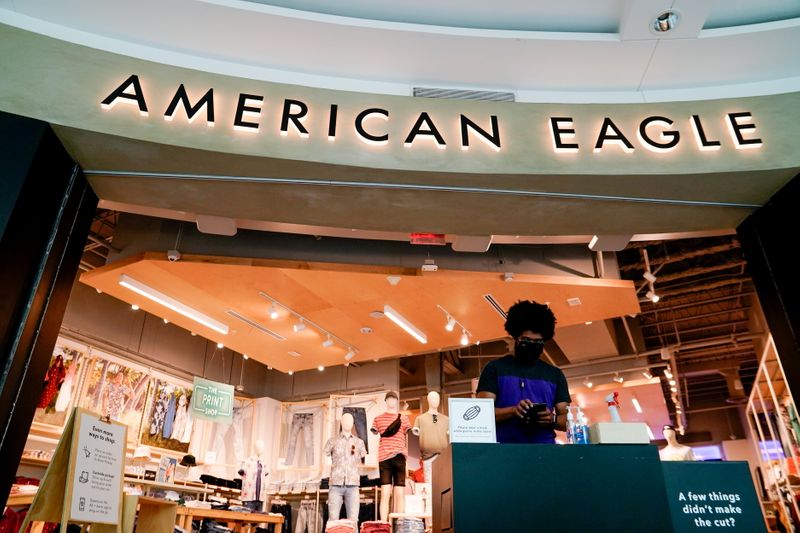 FILE PHOTO: An American Eagle Outfitters employee waits for customers at a cleaning station outside a store in Arlington, Virginia