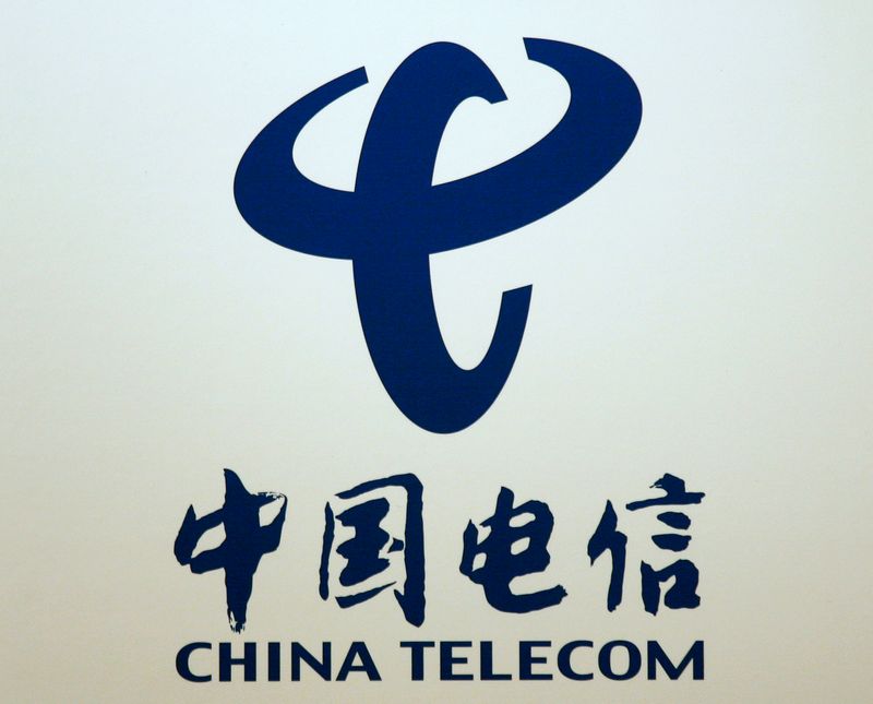 FILE PHOTO: Company logo of China Telecom is displayed at a news conference in Hong Kong