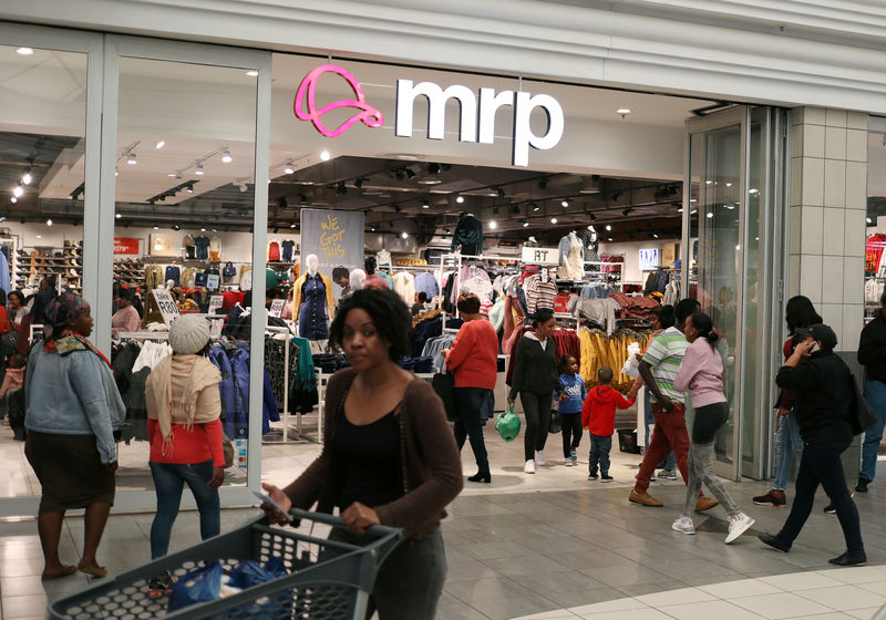 Shoppers walk past South Africa's Mr Price clothing store in Johannesburg