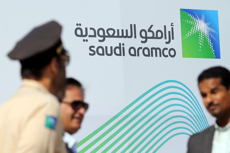 Logo of Aramco is seen as security personnel stand before the start of a press conference by Aramco at the Plaza Conference Center in Dhahran