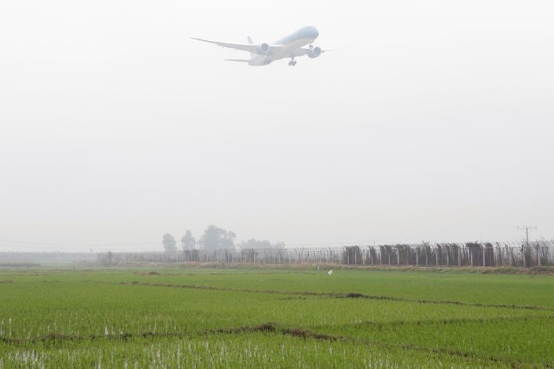 A Vietnam Airlines airplane prepares for landing at Noi Bai international airport in Hanoi, Vietnam