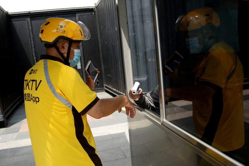 FILE PHOTO: Meituan delivery worker in Beijing amid COVID-19