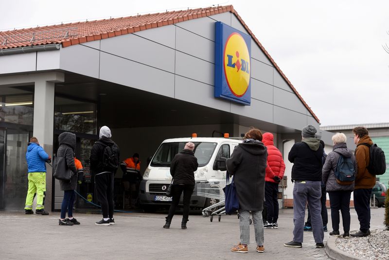 People queue in from on the Lidl shop to buy food during coronavirus disease (COVID-19) outbreak in Olsztyn