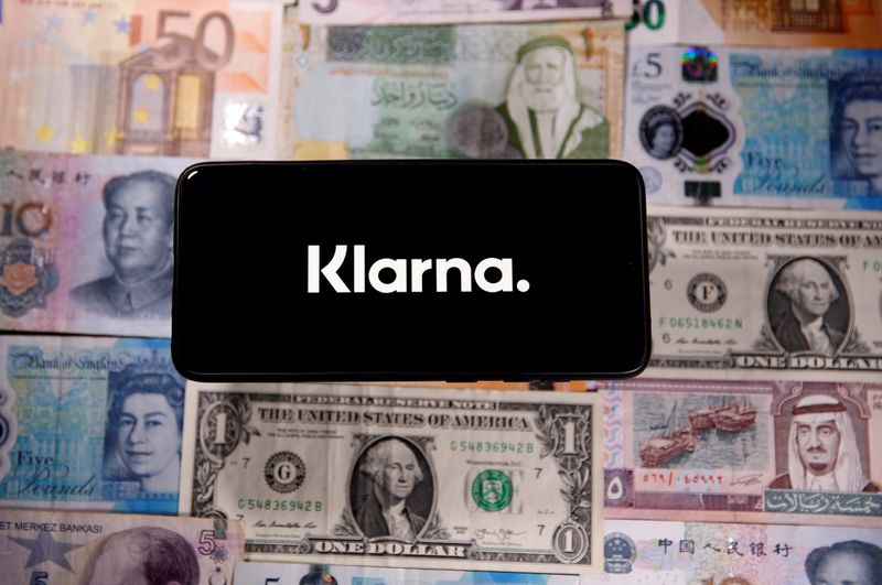 FILE PHOTO: A smartphone displays a Klarna logo on top of banknotes is in this illustration