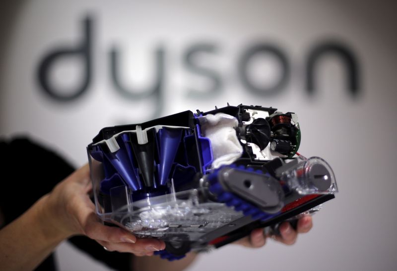 FILE PHOTO: A Dyson employee shows a Dyson 360 Eye robot vacuum cleaner without its cover during the IFA Electronics show in Berlin