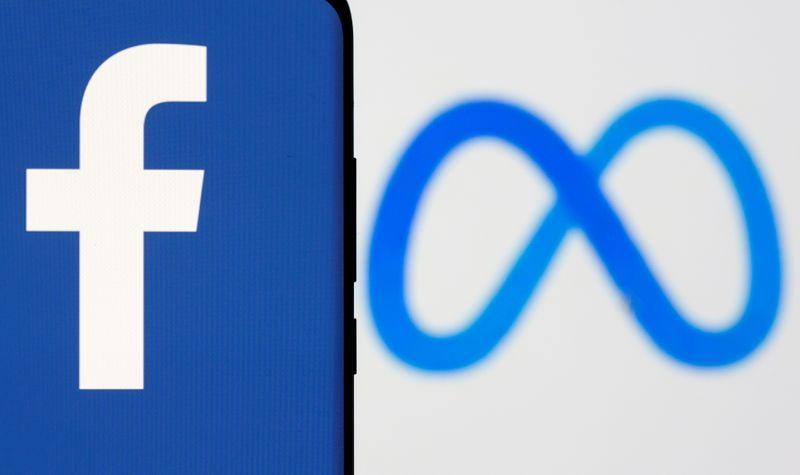 FILE PHOTO: Facebook's new rebrand logo Meta is displayed behind a smartphone with the Facebook logo in this illustration picture