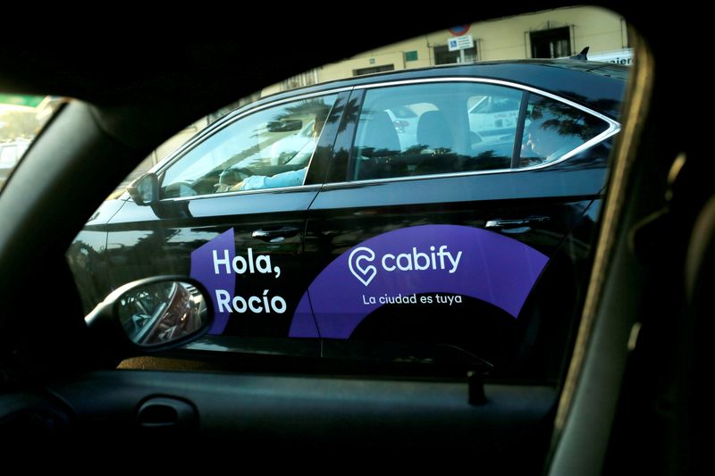 FILE PHOTO: A Cabify taxi car is seen through the window of a car in Malaga