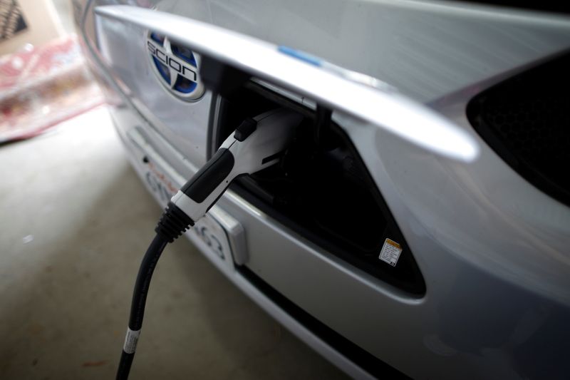 FILE PHOTO: A computer science professor's electric car is plugged in in her garage in Irvine, California