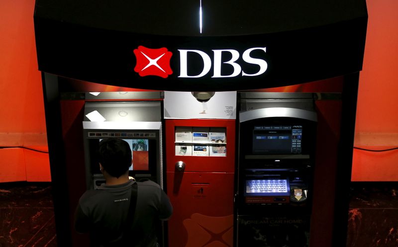 FILE PHOTO: A man uses a DBS automated teller machine in Singapore