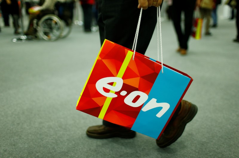 A shareholder carries a bag with the logo of E.ON during the company's annual shareholders meeting in Essen
