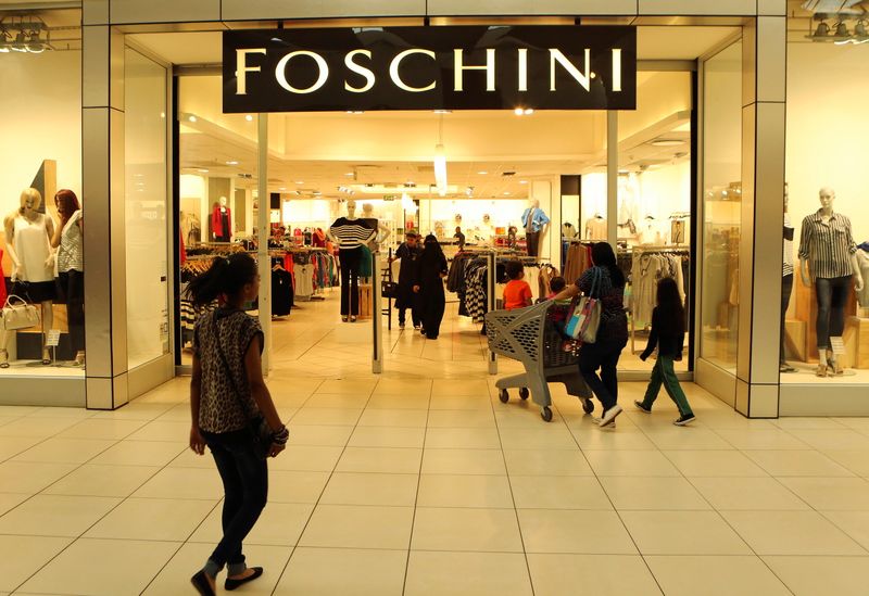 FILE PHOTO: A shopper walks past a Foschini store at a shopping centre in Lenasia, south of Johannesburg