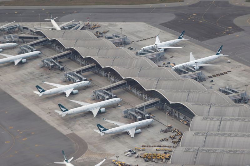 eatFILE PHOTO: Aircraft of Cathay Pacific are parked on the tarmac at the Hong Kong International Airport, Hong Kong