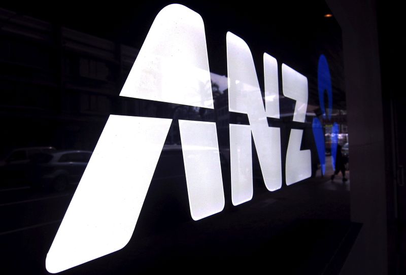 FILE PHOTO: A man walks past a branch of the Australia and New Zealand Banking Group Ltd (ANZ) in Sydney
