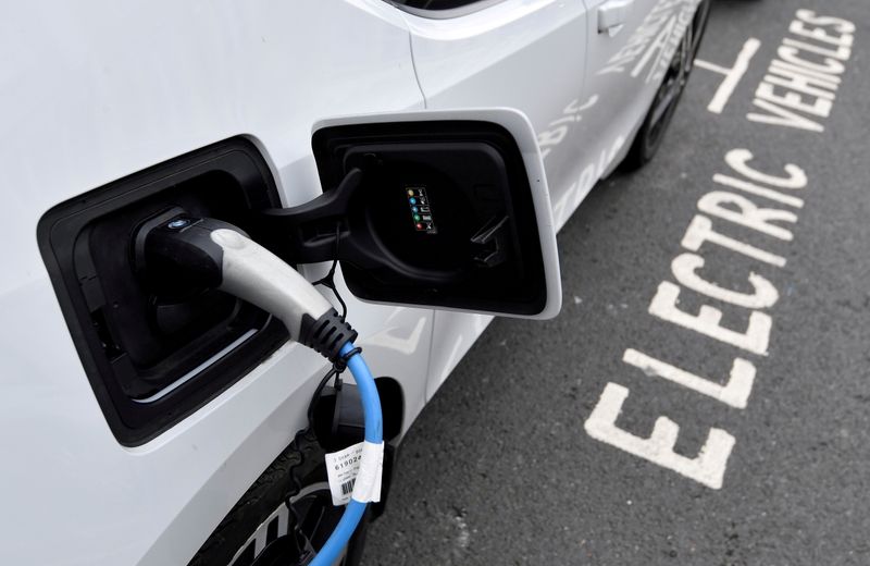 FILE PHOTO: An electric car is charged at a roadside EV charge point, London