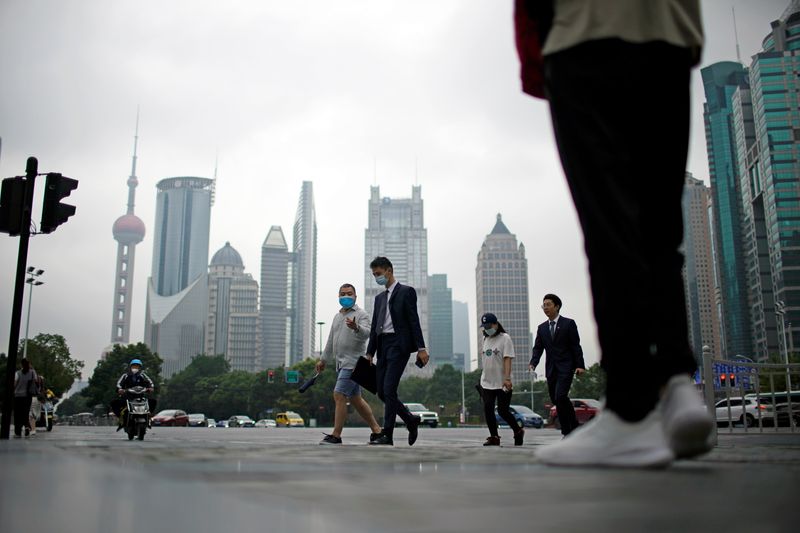 People walk along at financial district of Lujiazui in Shanghai