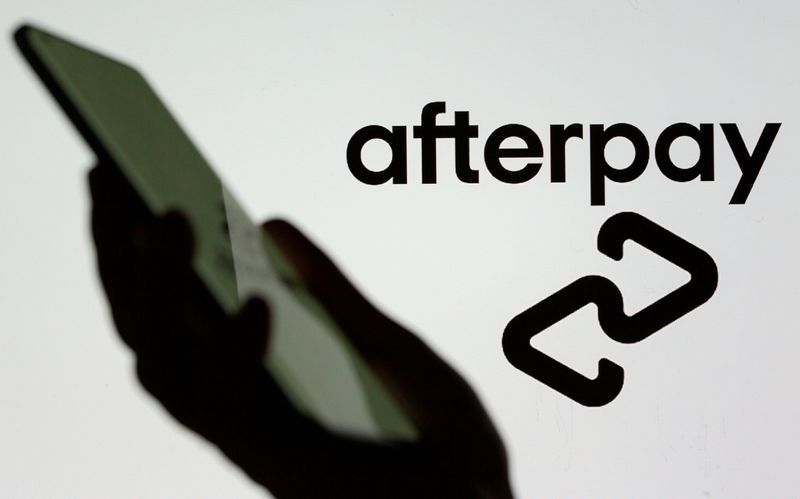 FILE PHOTO: A smartphone is held in front of a displayed Afterpay logo