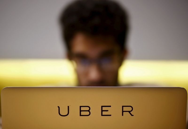 FILE PHOTO: Employee works inside the office of U.S. online cab-hailing company Uber on the outskirts of New Delhi