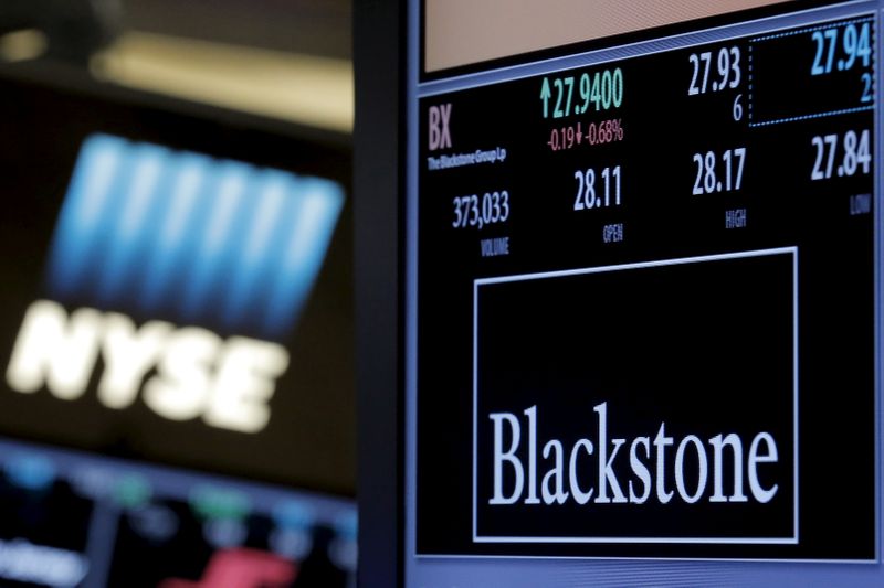 FILE PHOTO: FILE PHOTO: The ticker and trading information for Blackstone Group is displayed at the post where it is traded on the floor of the New York Stock Exchange