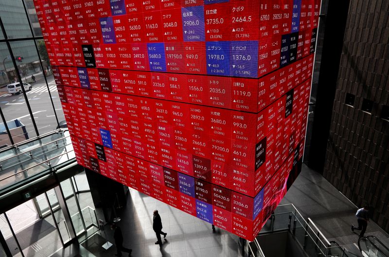 An electronic stock quotation board is displayed inside a conference hall in Tokyo
